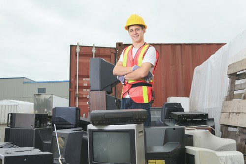 Workers loading construction debris into a lockable skip